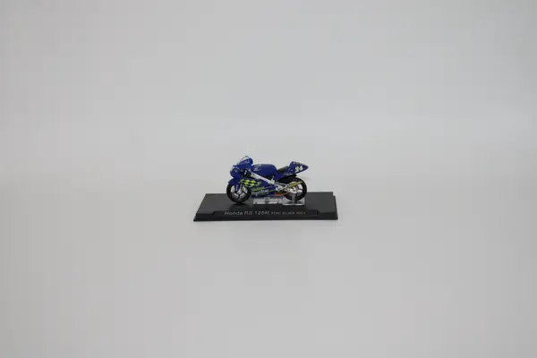 Deagostini blue Honda RS 125R Toni Elias 2001 No. 24 diecast motorcycle for sale on a stand.