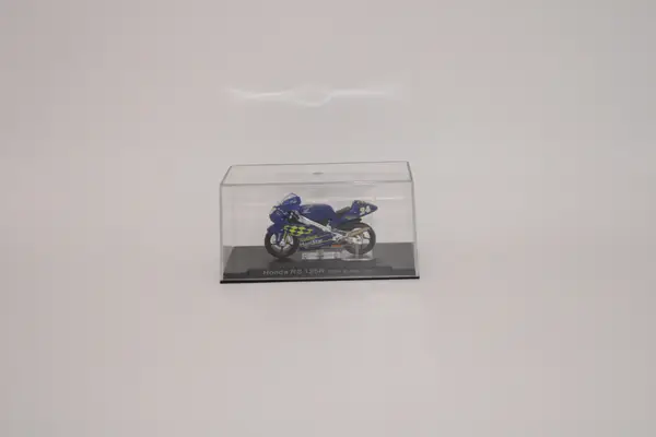 Deagostini blue Honda RS 125R Toni Elias 2001 No. 24 diecast motorcycle for sale on a stand in a clear plastic case.