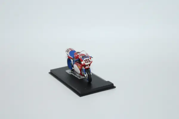 Deagostini red, blue and white Ducati No. 155 Ben Bostrom diecast motorcycle model on a stand.