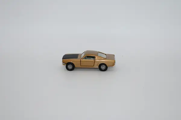 Corgi GOLD AND BLACK FORD MUSTANG FASTBACK COUPE diecast car.